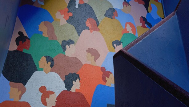 A staircase with a colorful mural of stylized human figures. - Nice room with private bathroom La Condesa C16 (Ciudad de México)