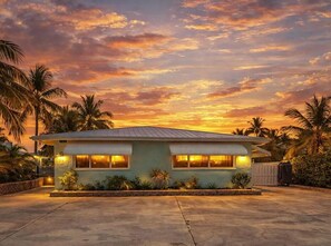 A single-story house with a flat roof, two visible windows, and a small front porch. - *NEW* Reel Escape~50'Dock!!~Pet Friendly!~Grill! (Marathon)