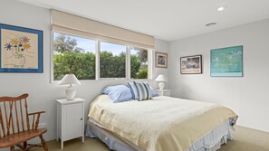 A bedroom with a bed, two bedside lamps, a chair, and artwork on the walls. - The Quiet Nook - Point Lonsdale (Point Lonsdale)