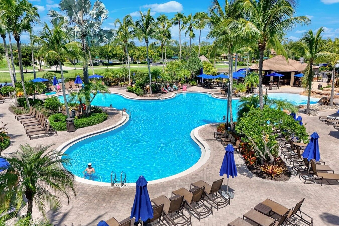 Zwembadgedeelte van een resort, met ligbedden en parasols.