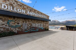 The exterior of the Dillon Amphitheater with a stone facade and a clear view of the mountains in the background. - Spacious Mountain Home, Private Deck, Central Location in Dillon (Dillon)