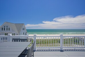 A coastal property with a white deck and a view of the beach and ocean. - Oceanfront pool, hot tub and game room (North Topsail Beach)