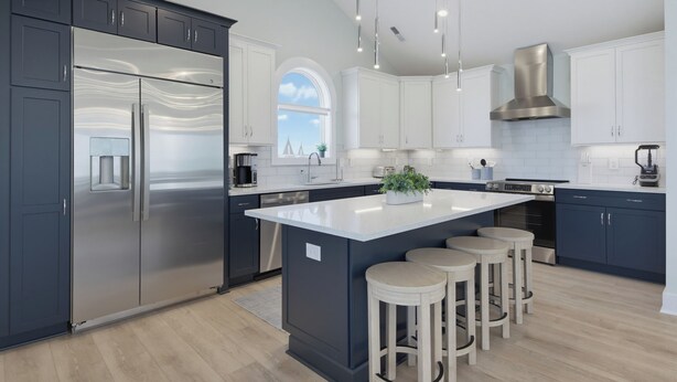 Una cocina moderna con una isla central, muebles oscuros, electrodomésticos de acero inoxidable e iluminación colgante.