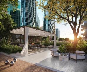An outdoor patio area with seating, a grill, and a pergola. - Luxury 1-Bedroom Residence at Viceroy Brickell (Miami)