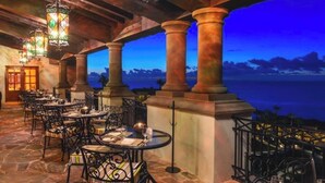 An outdoor dining area with stone flooring, metal chairs, and tables set for dining. - Pueblo Bonito Sunset Beach Suite with 2 bedrooms/AC in pleasant Cabo San Lucas (Cabo San Lucas)