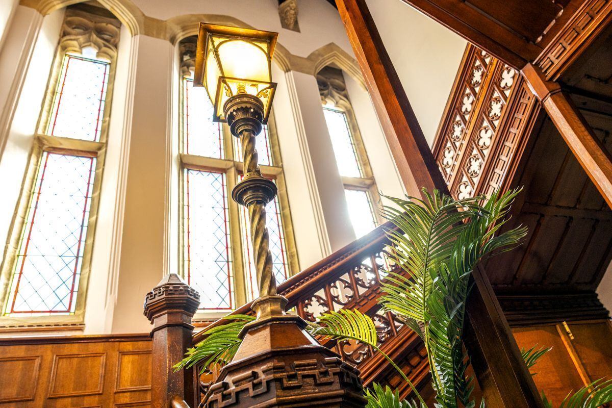 A staircase with wooden railings and a decorative lamp post.