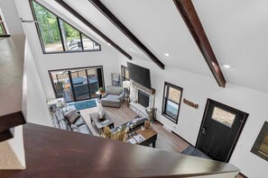 A spacious living area with a fireplace, seating, and a view of the outdoors.