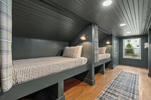 A room with two bunk beds, a window with a view, and a ceiling with recessed lighting. - Private Mini Golf Course, Main House + Clubhouse, HotTub, Games, Walk to Bars (Nashville)