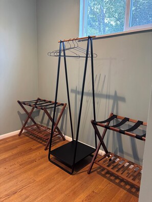 A room with a wooden floor, a window with a view of trees, and a metal drying rack. - Monterey Getaway - Fabulous 3-bedroom house in Monterey (Monterey)