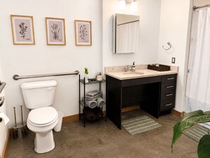 Ein modernes Badezimmer mit Toilette, Waschbecken und Handtuchhalter.