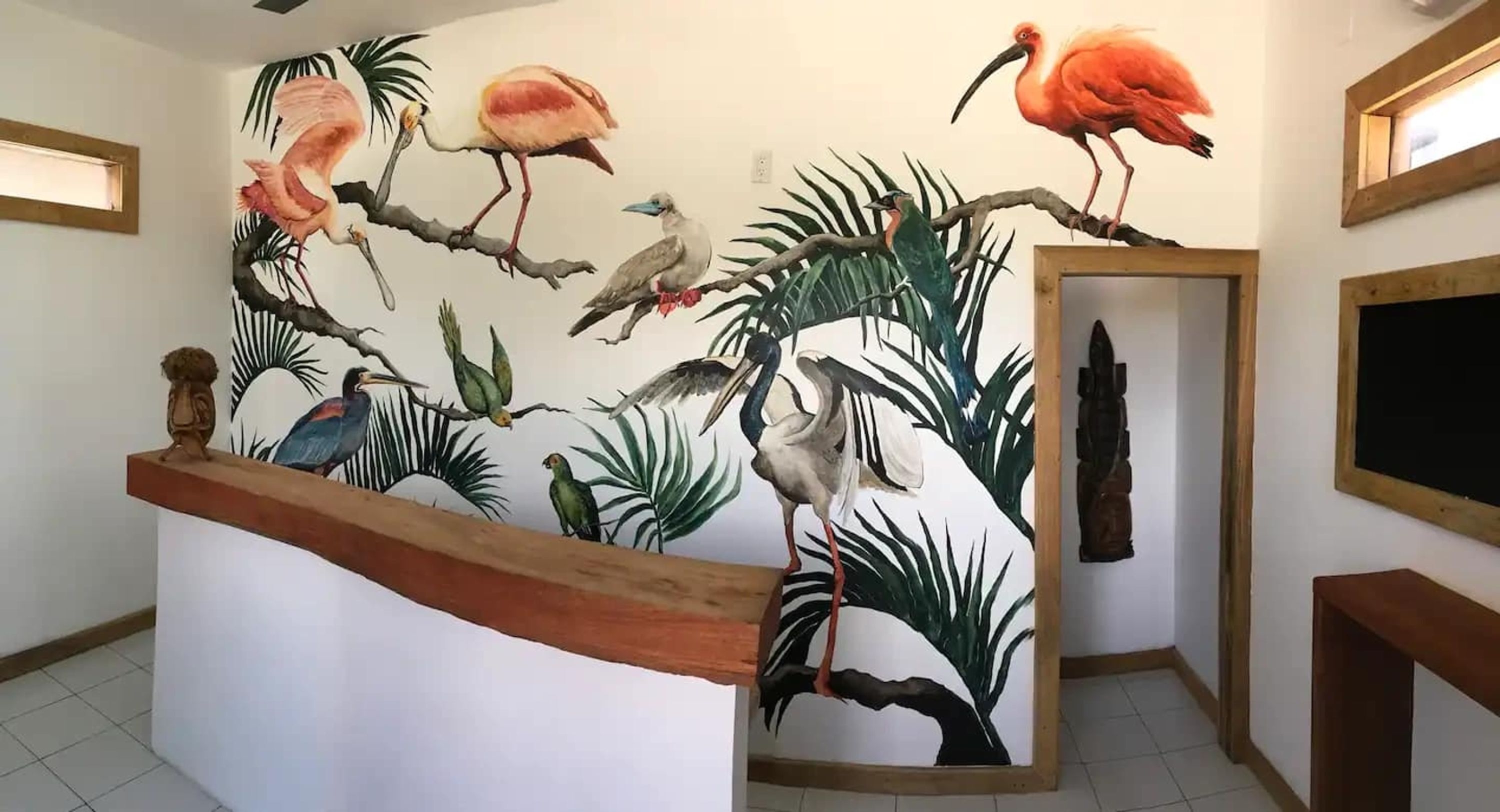 Un mural con aves tropicales en una pared.