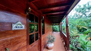A wooden building with a covered porch, a sign reading 'Bicinvidas', and a potted plant. - An unrivalled Location: Situated in the heart of Costa Rica's adventure capital, (Alajuela)