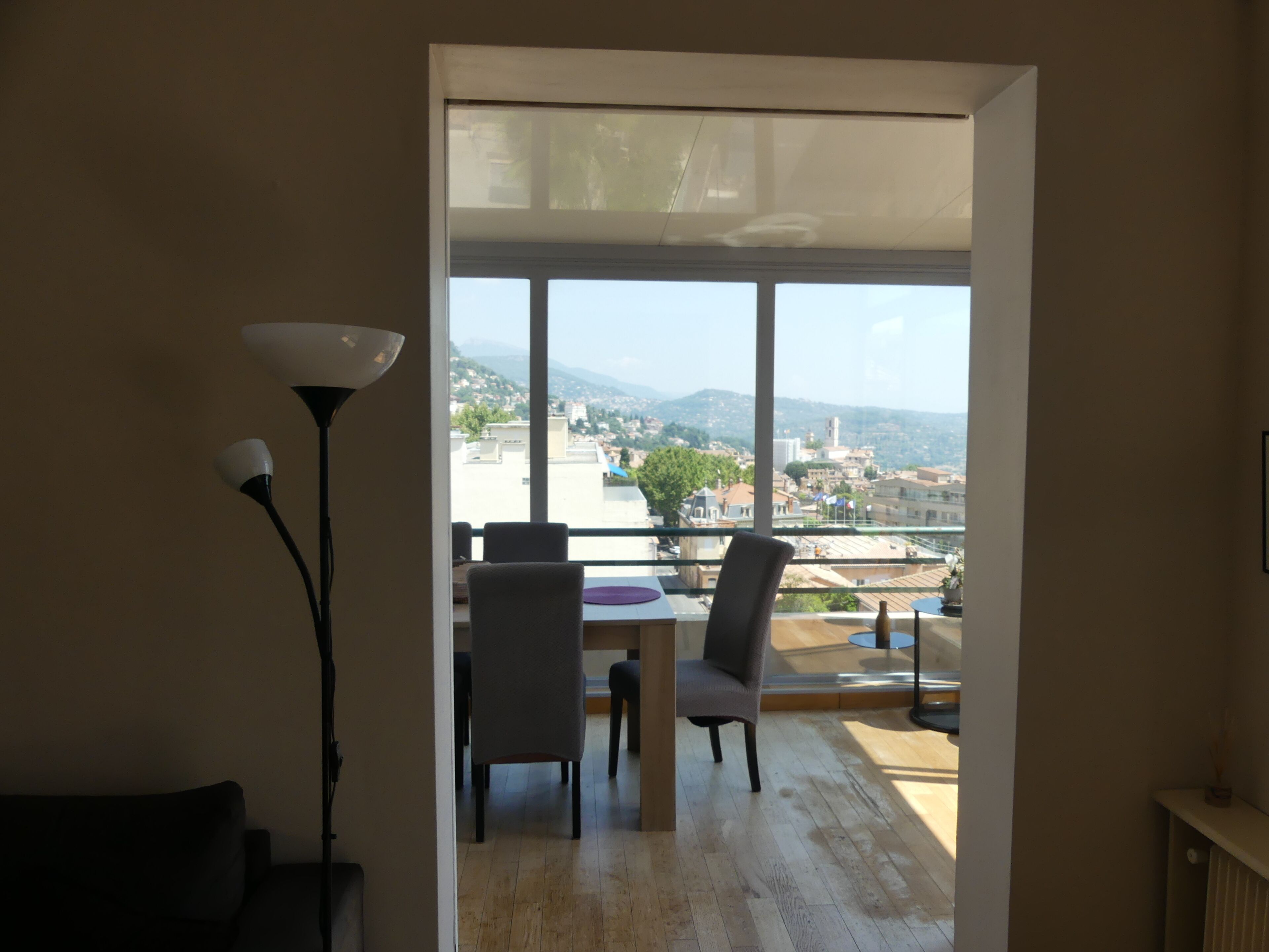 An interior space with a view of a cityscape through large windows.