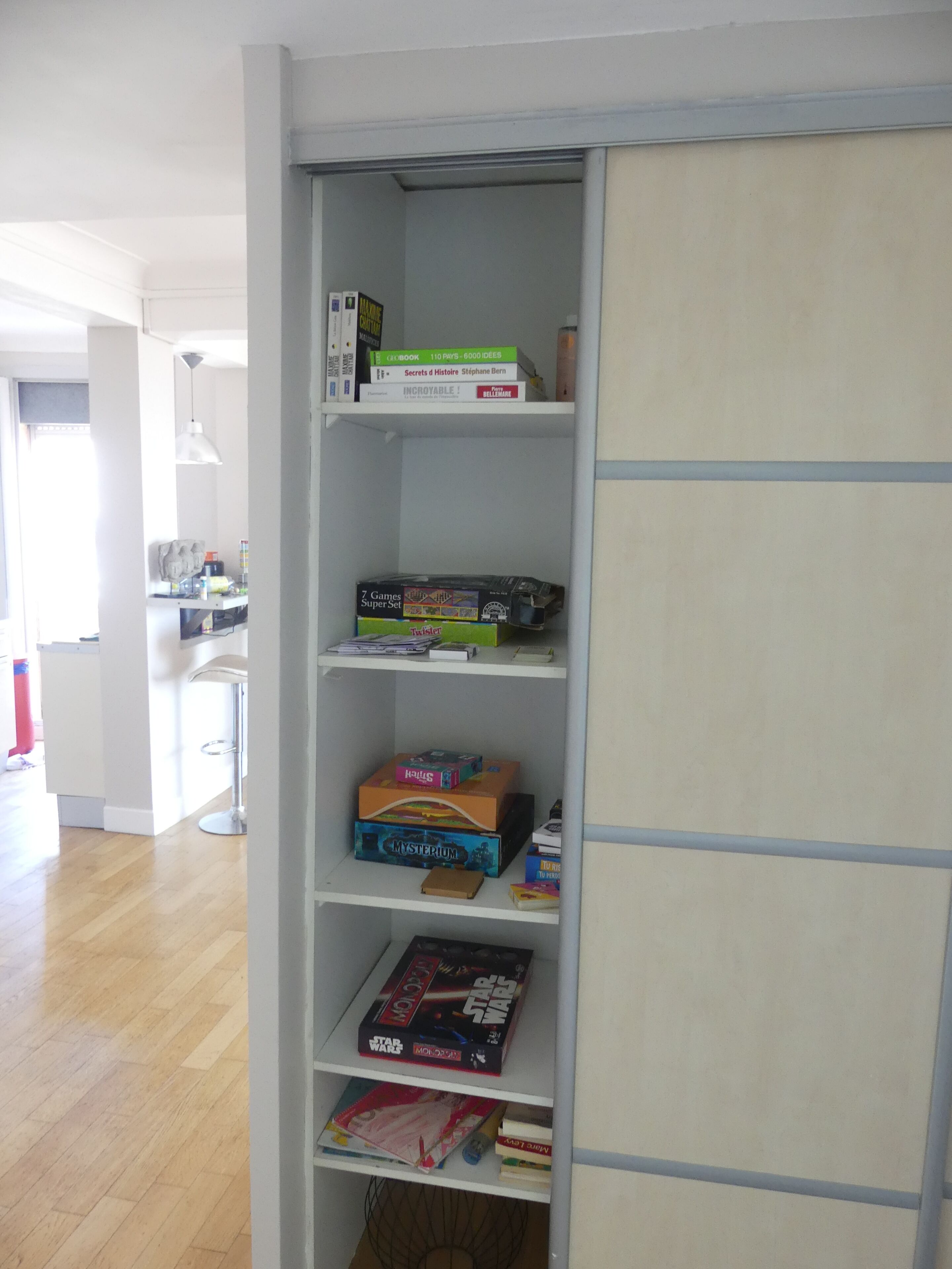 A bookshelf with various board games and books.