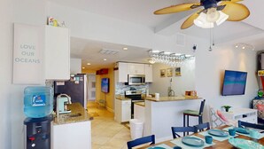 A modern kitchen with a microwave, oven, and water dispenser. - Private Elevator, Spectacular Pool & Marina Views, Steps to Madeira Beach & John's Pass Village (Madeira Beach)