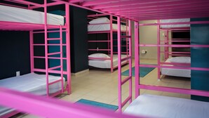 A dormitory room with bunk beds, a blue mat, and a white wall. - Casa Local Mestizo Hostal (Mexico City)