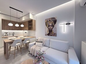 A modern interior with a dining area, a sofa, and a wall-mounted artwork. - Stylish City 2BR Apartment | Ad Residences (Thessaloniki)