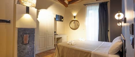 Una habitación de hotel con cama, escritorio, espejo y baño.