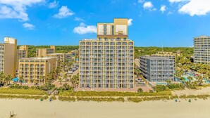 A high-rise hotel with multiple floors, a rooftop terrace, and a beachside location. - Sea Mist 20509 Direct Ocean Front Condo (Myrtle Beach)