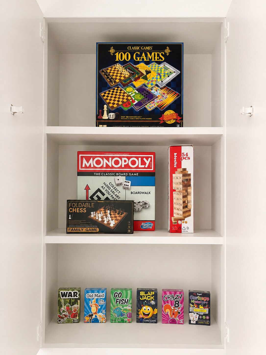 A shelf with various board games including Monopoly, Chess, and others.