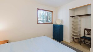 A bedroom with a bed, a dresser, a mirror, and a wardrobe. - 1BR Condo w/Game Room, Pool & Hot Tub (Bend)