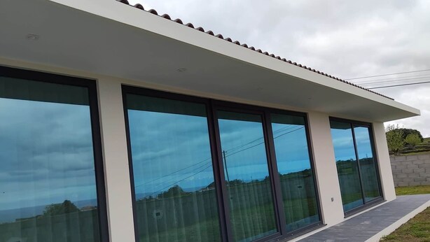 A modern building with large glass windows and a flat roof. - Casa das Hortênsias (Nossa Senhora do Pilar Terceira)