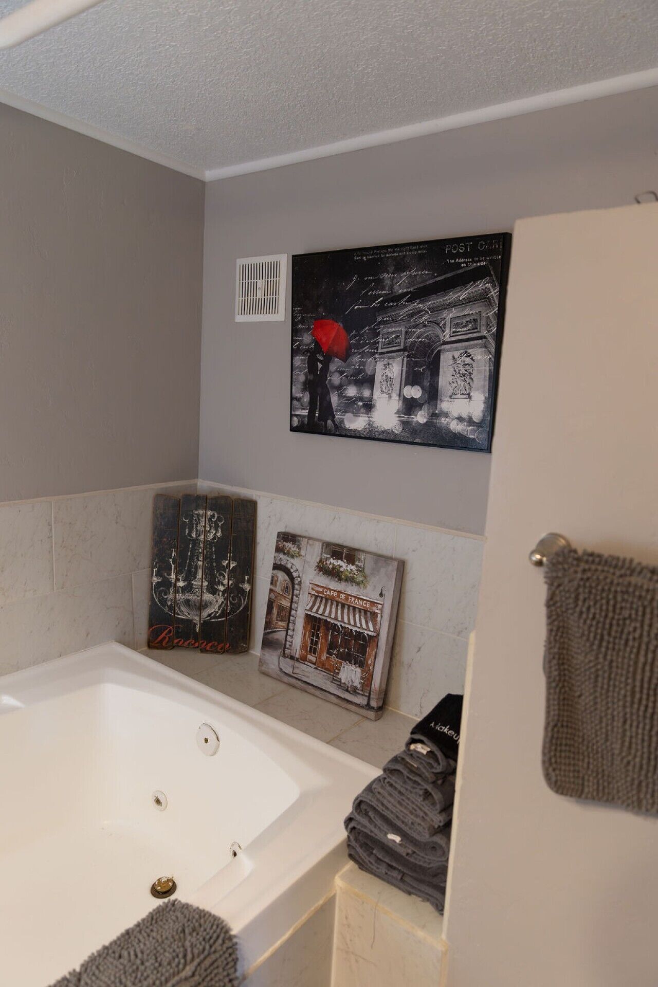 Une salle de bain avec une baignoire, une douche et un porte-serviettes.