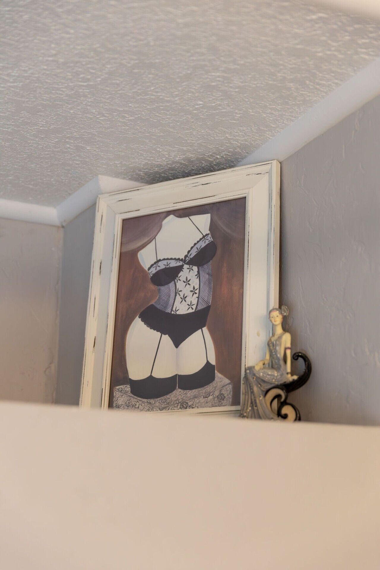 A framed artwork on a wall.