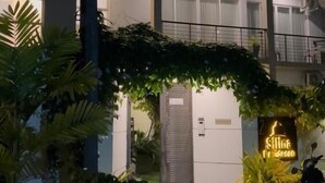 A multi-story building with balconies and a neon sign. - Silina Airport Residence & Transit Hotel (Katunayake)
