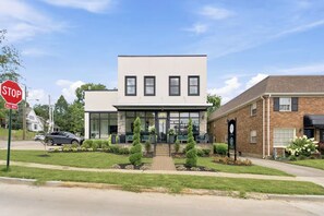 A modern building with a flat roof, large windows, and a brick facade.