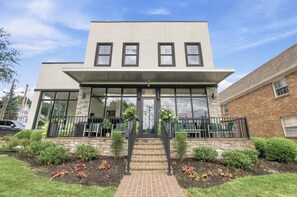 A modern two-story building with a flat roof, large windows, and a stone facade. - Charming Modern Studio Stay - Walk to Chevy Chase (Lexington)