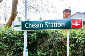 A sign for Cheam Station with a Southern logo. - Hybrid Resi Cheam - Two Bedroom Apartment (Sutton)