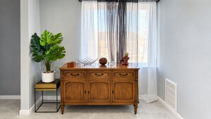 A wooden cabinet with drawers and a potted plant beside it. - Wonderful two story, 2-bedroom apartment with AC in vibrant Detroit (Detroit)