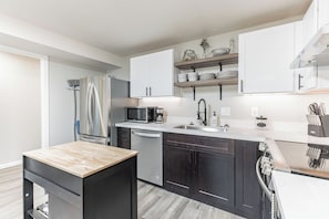 A modern kitchen with stainless steel appliances, a dishwasher, and a coffee maker. - Peaceful 1-bedroom apartment with private entry in charming Snohomish (Snohomish)
