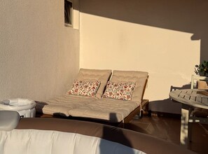 A bedroom with a bed, pillows, a bedside table, and a small table with a plant. - Tina Sea View Retreat (Vodice)