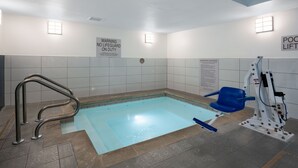 A swimming pool with a lifeguard chair, a pool lift, and a no lifeguard on duty sign. - Studio Suite w/ Jetted Tub | Free Breakfast! (West Des Moines)