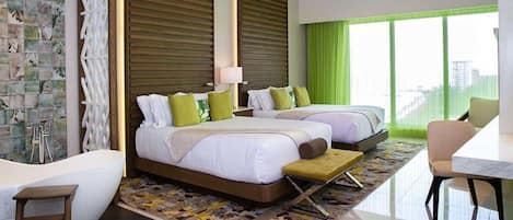 A hotel room with a large bed, a separate bed, a bathtub, and a dining area.