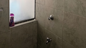 A bathroom with a shower, a window, and a bottle of shampoo. - Cozy one bedroom apartment (Ongata Rongai)