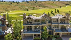 A multi-story house with a patio, a fire pit, and a view of a golf course. - Abode at White Clouds, hot tub, Sun Valley (Sun Valley)