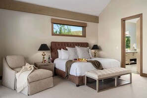 A bedroom with a large bed, bedside tables, a chair, and a bench. - Abode at White Clouds, hot tub, Sun Valley, minutes to skiing (Sun Valley)