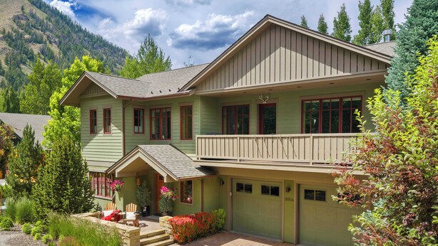 A two-story house with a balcony, a garage, and a front porch with outdoor seating. - Abode at Ketchum Escape, walk to Main St, ensuites (Ketchum)