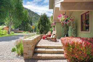 A house with a stone porch, outdoor seating, and a speed limit sign. - Abode at Ketchum Escape, walk to Main St, ensuites, chef's kitchen (Ketchum)