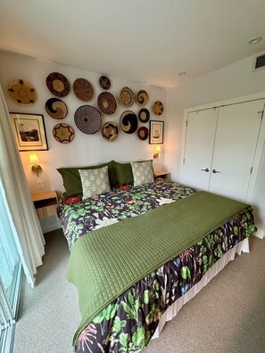 A bedroom with a bed, a nightstand, a wall-mounted lamp, and a wardrobe. - Modern Luxury Kitsilano Apartment (Vancouver)