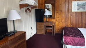 A room with a bed, a desk with a chair, a television, a lamp, and a wardrobe. - Cozy 1BR hotel room, Hamilton - #336 Endawonnda (Hamilton)