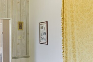 A wall with a framed picture and a plaque. - Charming Apartment w/ Shared Deck & Lake Views (Lawrenceville)