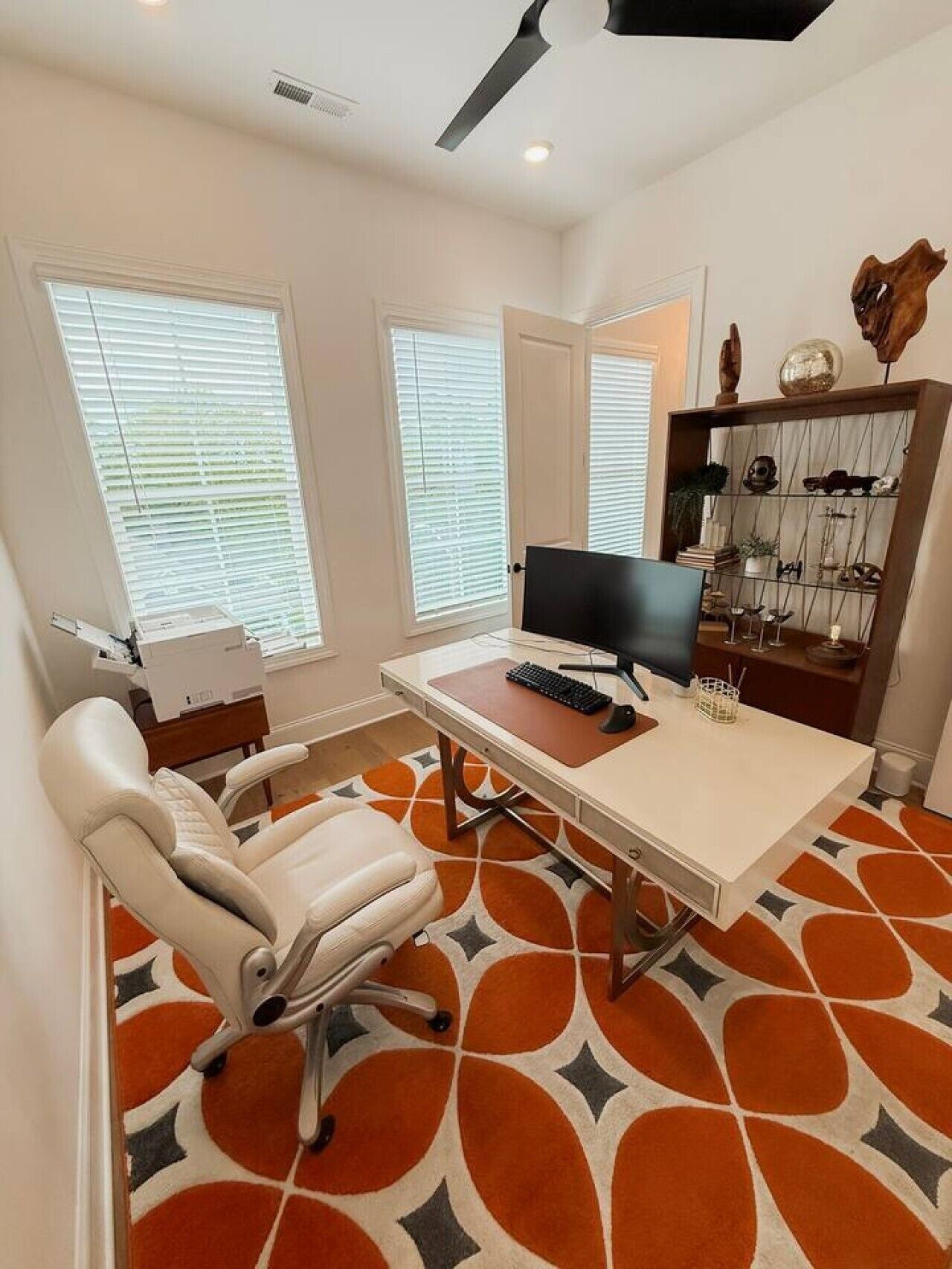 A modern office space with a desk, computer, and office chair.