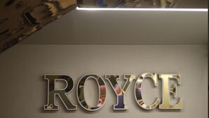A metallic sign with the word 'ROYCE' in a reflective font. - Hotel Royace Executive By Glitz Hotels (Mumbai)
