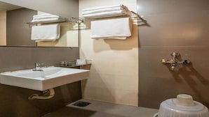 A bathroom with a sink, towel rack, mirror, and toilet. - Hotel Royace Executive By Glitz Hotels (Mumbai)
