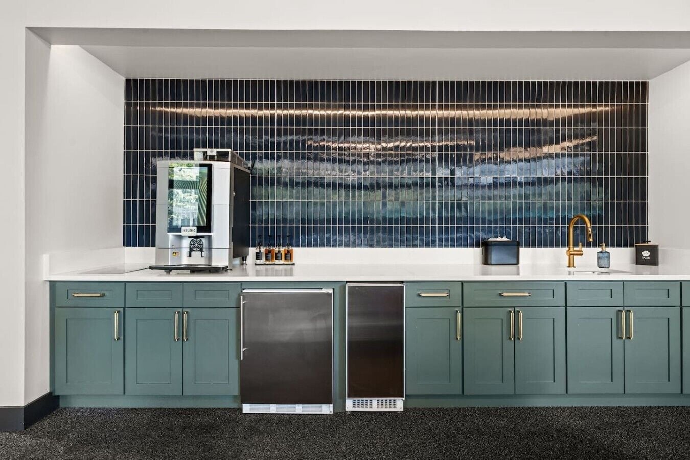 A kitchen with a built-in refrigerator, a microwave, and a sink with a gold faucet.