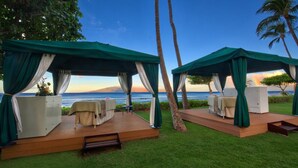 Two outdoor cabanas with a view of the ocean, each with a bed and a small table. - Maui 2BR Island-View Villa at Marriott’s Ocean Club - Full Kitchen & Balcony (Lahaina)